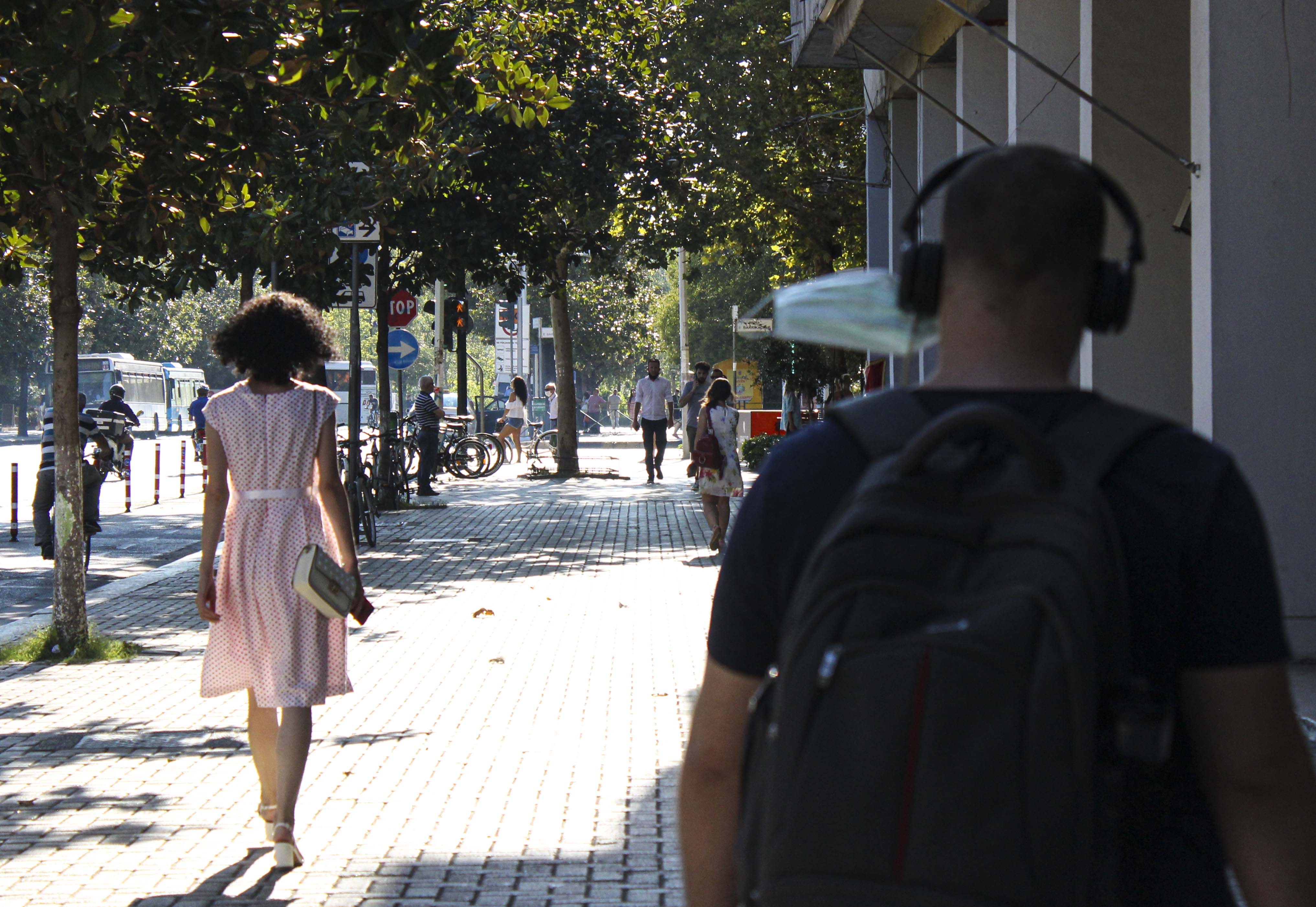 People walks down the street in Tiranaâs city centre on Thursday, Aug. 27, 2020. (Photo by Meng Wei)